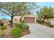 Charming single-story home with desert landscaping and a two-car garage on a sunny day at 2766 Mintlaw Ave, Henderson, NV 89044