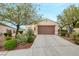 Charming single-story home with desert landscaping and a two-car garage on a sunny day at 2766 Mintlaw Ave, Henderson, NV 89044