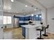 Open kitchen with breakfast bar seating, stainless appliances, and custom blue cabinetry at 2766 Mintlaw Ave, Henderson, NV 89044