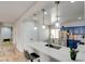 Kitchen island with stone countertop and pendant lights, complemented by stainless steel appliances at 2766 Mintlaw Ave, Henderson, NV 89044