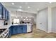 Open kitchen with breakfast bar, stainless appliances, custom cabinets with an open view to the living room at 2766 Mintlaw Ave, Henderson, NV 89044