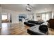 Open-concept living room with wood flooring, recessed lighting, and modern black leather furniture at 2766 Mintlaw Ave, Henderson, NV 89044