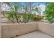 Balcony with textured stucco railing, offering outdoor space with tree-lined views at 3182 Tarpon Dr # 204, Las Vegas, NV 89120