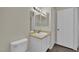 Bathroom featuring a single sink vanity, mirrored medicine cabinet, and wood-look flooring at 3182 Tarpon Dr # 204, Las Vegas, NV 89120
