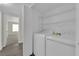 Convenient laundry room equipped with a washer, dryer, and built-in shelving for storage at 3182 Tarpon Dr # 204, Las Vegas, NV 89120