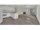Cozy living space featuring an open floor plan with kitchen, fireplace, and sliding glass door at 3182 Tarpon Dr # 204, Las Vegas, NV 89120
