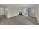 Cozy living room featuring a fireplace, neutral carpet, and sliding glass doors for natural light at 3182 Tarpon Dr # 204, Las Vegas, NV 89120