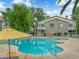 Inviting pool area, surrounded by landscaping, lounge chairs, and mature shade trees at 3182 Tarpon Dr # 204, Las Vegas, NV 89120