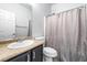 Cozy bathroom featuring granite countertops, a shower with a curtain, and tile flooring at 3257 Rushing Waters Pl, Las Vegas, NV 89135