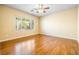Cozy bedroom with wood floors, a ceiling fan, and a large window that provides ample natural light at 3257 Rushing Waters Pl, Las Vegas, NV 89135