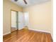 Bedroom with a ceiling fan, wood floors, and a mirrored closet at 3257 Rushing Waters Pl, Las Vegas, NV 89135