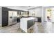 Modern kitchen featuring stainless steel appliances, dark cabinetry, and a stylish center island at 3257 Rushing Waters Pl, Las Vegas, NV 89135