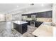 Modern kitchen with stainless steel appliances, dark cabinets, granite countertops, and a kitchen island at 3257 Rushing Waters Pl, Las Vegas, NV 89135