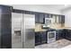 A well-equipped kitchen showcases stainless steel appliances and dark wood cabinets for a modern feel at 3257 Rushing Waters Pl, Las Vegas, NV 89135