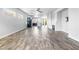 Spacious living room featuring wood-look tile flooring, neutral walls, and modern ceiling fan at 3257 Rushing Waters Pl, Las Vegas, NV 89135