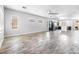 Bright and spacious living room with wood-look tile flooring, neutral walls and natural light at 3257 Rushing Waters Pl, Las Vegas, NV 89135