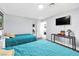 Spacious bedroom featuring two twin beds, neutral walls, and a TV with a small desk at 3499 Middlebury Ave, Las Vegas, NV 89121