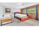 This cozy bedroom features wood-paneled walls and two beds to maximize sleeping space at 3499 Middlebury Ave, Las Vegas, NV 89121