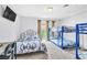 Bedroom featuring a full bed, a bunk bed, and a large window with natural light at 3499 Middlebury Ave, Las Vegas, NV 89121