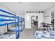 Spacious bedroom featuring two bunk beds, a standard bed, and a view to the kitchen through sliding barn doors at 3499 Middlebury Ave, Las Vegas, NV 89121