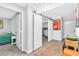 Hallway boasts a sliding barn door and access to a bedroom with a bed and end table at 3499 Middlebury Ave, Las Vegas, NV 89121