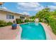 Beautiful in-ground pool surrounded by lush greenery and well-manicured landscaping, perfect for relaxation at 3499 Middlebury Ave, Las Vegas, NV 89121