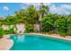 In-ground pool surrounded by lush landscaping, providing a serene and private backyard oasis at 3499 Middlebury Ave, Las Vegas, NV 89121