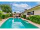 Inviting in-ground pool with a view of the home and lush landscaping, ideal for outdoor entertaining at 3499 Middlebury Ave, Las Vegas, NV 89121