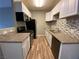 Modern kitchen featuring white cabinets, granite countertops, and updated appliances at 4730 E Craig Rd # 1149, Las Vegas, NV 89115
