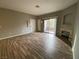 Spacious living room with wood flooring, fireplace, and sliding door access to balcony at 4730 E Craig Rd # 1149, Las Vegas, NV 89115