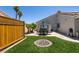Private backyard features a lawn, patio with outdoor seating, and a storage shed at 5025 Chambliss Dr, Las Vegas, NV 89130