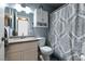 Cozy bathroom features a single sink vanity with a patterned shower curtain at 5025 Chambliss Dr, Las Vegas, NV 89130