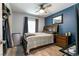 This bedroom has a blue accent wall and a bed with wood trim at 5025 Chambliss Dr, Las Vegas, NV 89130