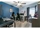 This bedroom has multiple monitors on the desk and a nice ceiling fan at 5025 Chambliss Dr, Las Vegas, NV 89130