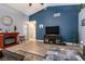Comfortable living room featuring a fireplace, wood-look floors, and neutral color palette at 5025 Chambliss Dr, Las Vegas, NV 89130