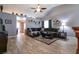 Spacious living room with vaulted ceiling, wood-look floors, and modern decor at 5025 Chambliss Dr, Las Vegas, NV 89130