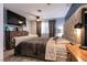 This main bedroom offers a big bed and a wall-mounted television at 5025 Chambliss Dr, Las Vegas, NV 89130