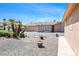 Serene backyard retreat with desert landscaping, a screened-in porch, and an outdoor space at 5060 Wheatland Dr, Pahrump, NV 89061