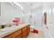 Bright bathroom with a light-colored vanity, large mirror, and a shower-tub combo at 5060 Wheatland Dr, Pahrump, NV 89061