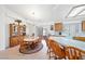 Bright dining area features a chandelier and wooden table with seating for six, adjacent to the kitchen with tile flooring at 5060 Wheatland Dr, Pahrump, NV 89061