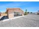 Detached garage with open door, palm trees, and a desert landscape at 5060 Wheatland Dr, Pahrump, NV 89061