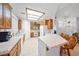 Spacious kitchen with tile countertops, wooden cabinets, and ample natural light near the living area, great for entertaining at 5060 Wheatland Dr, Pahrump, NV 89061
