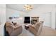 Bright living room with comfortable armchairs, a stone fireplace, and a large television for entertainment at 5060 Wheatland Dr, Pahrump, NV 89061