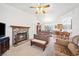 Spacious living room with a stone fireplace, tile floors, and an open layout connecting to the dining area and kitchen at 5060 Wheatland Dr, Pahrump, NV 89061