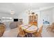 Open-concept living area with dining, kitchen, and lounge spaces, featuring neutral tones and comfortable furnishings at 5060 Wheatland Dr, Pahrump, NV 89061