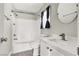 Bathroom with white tile tub, updated vanity, and brushed nickel fixtures at 5200 Paradise Skies Ave, Las Vegas, NV 89156