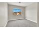Bedroom with neutral carpet and paint; sunlit from window at 5200 Paradise Skies Ave, Las Vegas, NV 89156