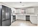 Modern kitchen equipped with stainless steel appliances, white cabinetry, and ample countertop space at 5200 Paradise Skies Ave, Las Vegas, NV 89156