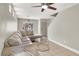 Comfortable living room featuring tile flooring, natural light, and a cozy sectional sofa at 5200 Paradise Skies Ave, Las Vegas, NV 89156