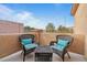 Relaxing covered balcony area with stylish wicker furniture and a view at 6061 Moonlight Sonata Ave, Las Vegas, NV 89122